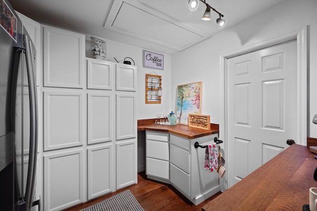 kitchen featuring refrigerator, butcher block countertops, white cabinetry, and dark hardwood / wood-style floors