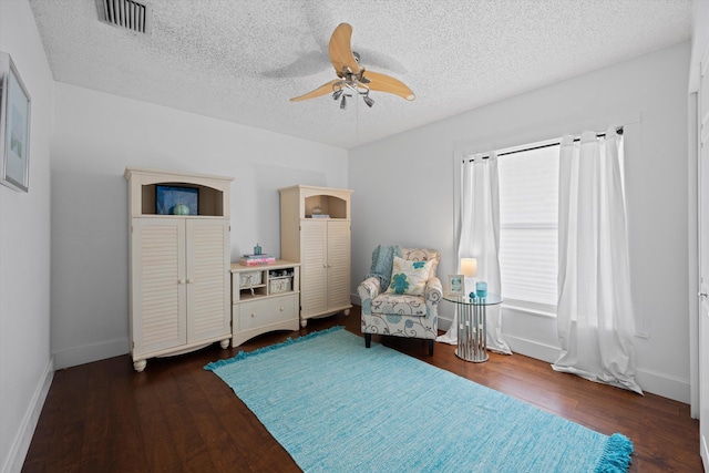 sitting room featuring ceiling fan, a textured ceiling, and dark hardwood / wood-style flooring