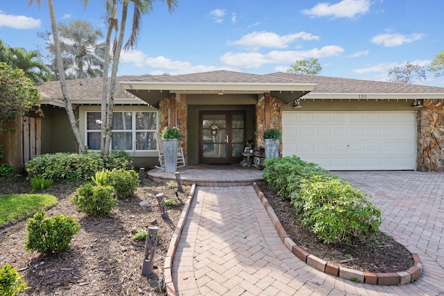 view of front of house with french doors and a garage