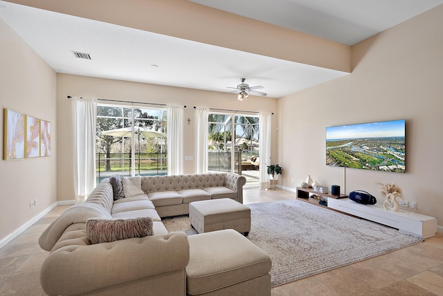 living area with visible vents, baseboards, a ceiling fan, and light tile patterned flooring