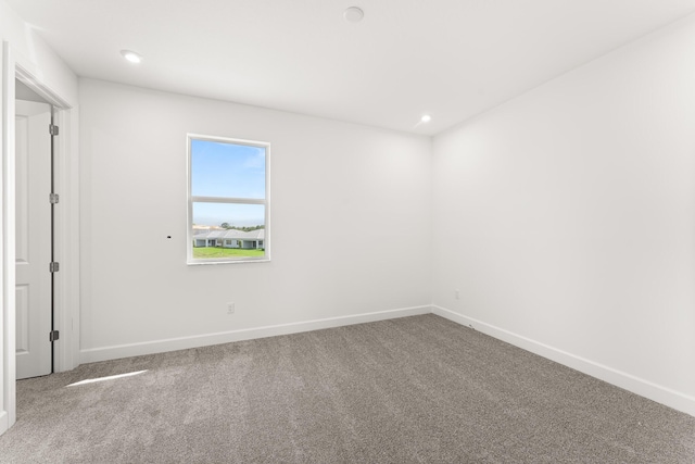 carpeted empty room featuring baseboards and recessed lighting