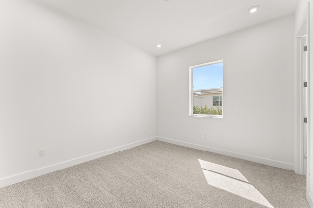 spare room with recessed lighting, carpet flooring, and baseboards