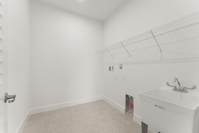 washroom featuring washer hookup, laundry area, a sink, and baseboards