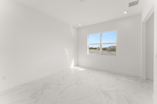 empty room with recessed lighting, marble finish floor, visible vents, and baseboards