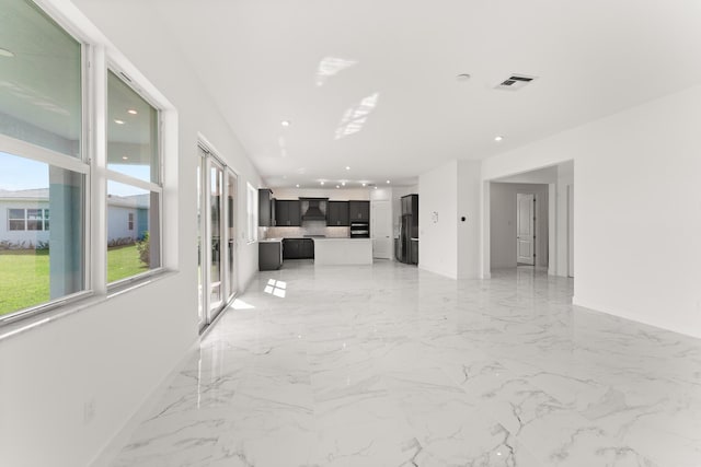 unfurnished living room with marble finish floor, baseboards, visible vents, and recessed lighting