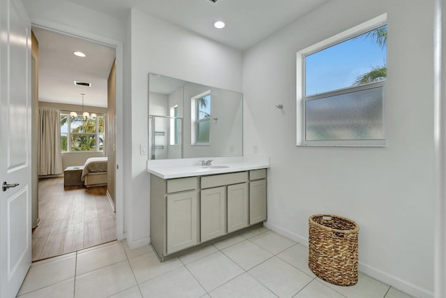 ensuite bathroom with recessed lighting, vanity, ensuite bath, and an inviting chandelier