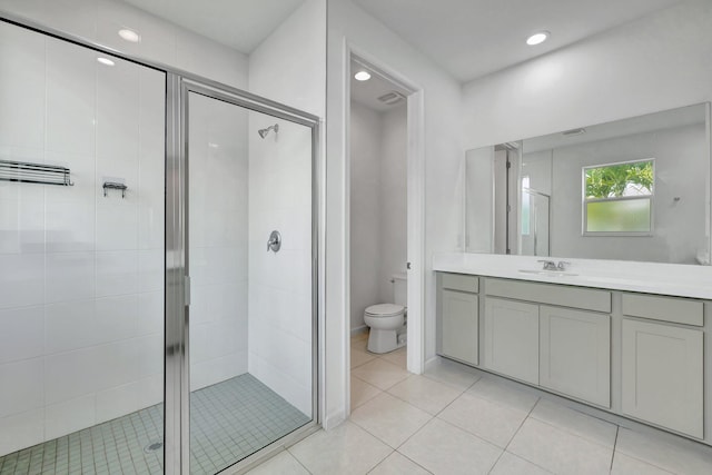 bathroom with toilet, tile patterned floors, vanity, a shower stall, and recessed lighting