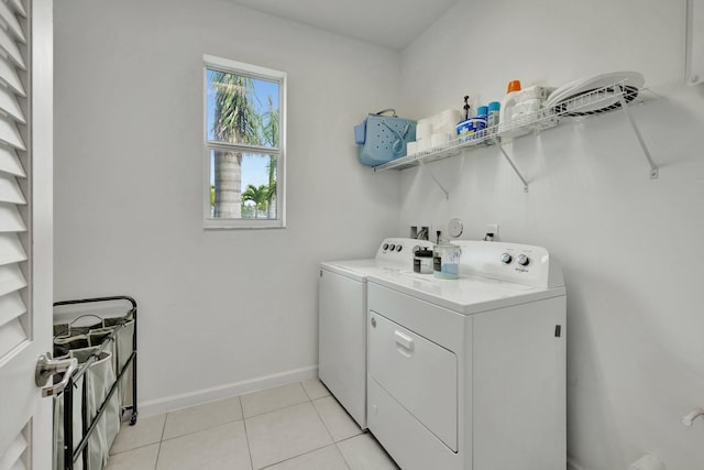 laundry room with baseboards, laundry area, light tile patterned flooring, and washer and dryer