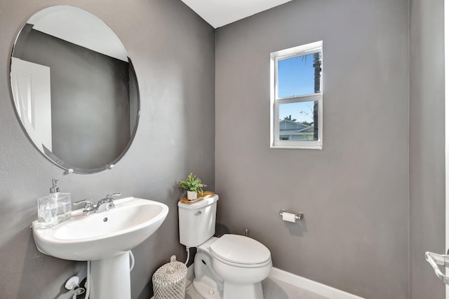 bathroom featuring toilet and baseboards