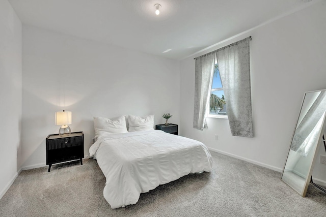 carpeted bedroom featuring baseboards