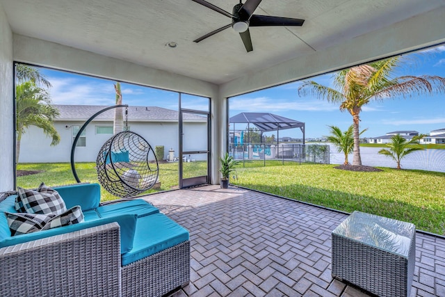 sunroom / solarium featuring ceiling fan