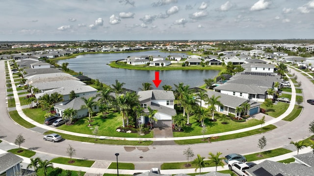 drone / aerial view with a water view and a residential view