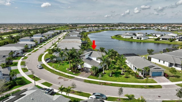 bird's eye view with a water view and a residential view