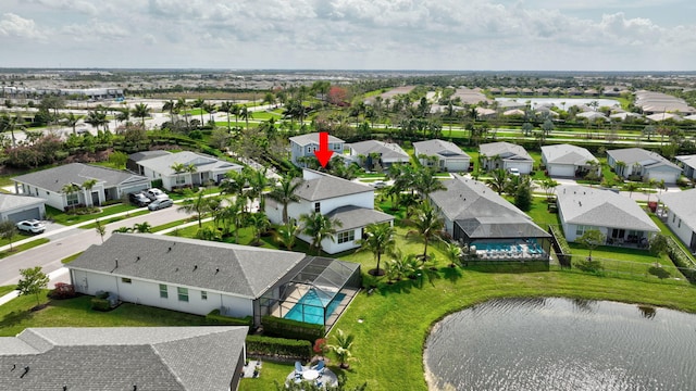 birds eye view of property with a water view and a residential view