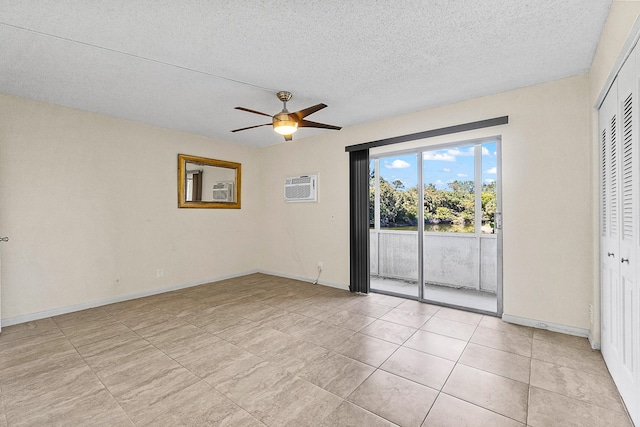 unfurnished room with baseboards, a textured ceiling, a wall mounted air conditioner, and a ceiling fan