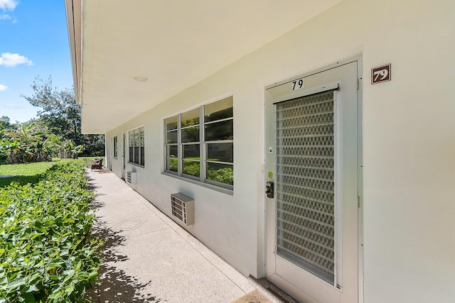 doorway to property with stucco siding and a patio