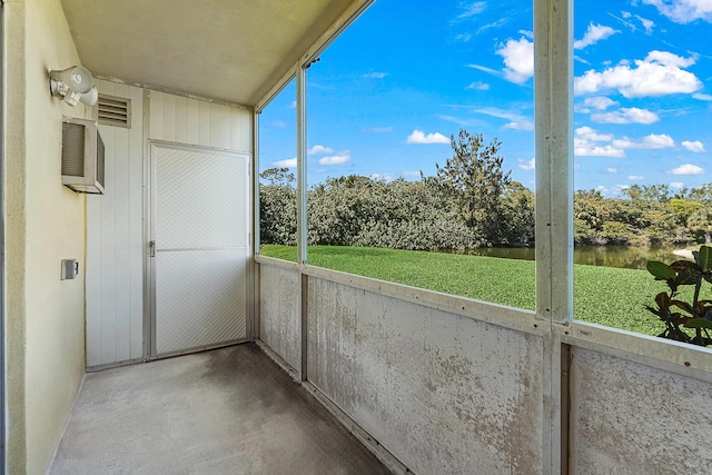 unfurnished sunroom featuring a water view