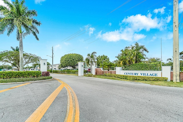 view of street featuring street lights and a gated entry