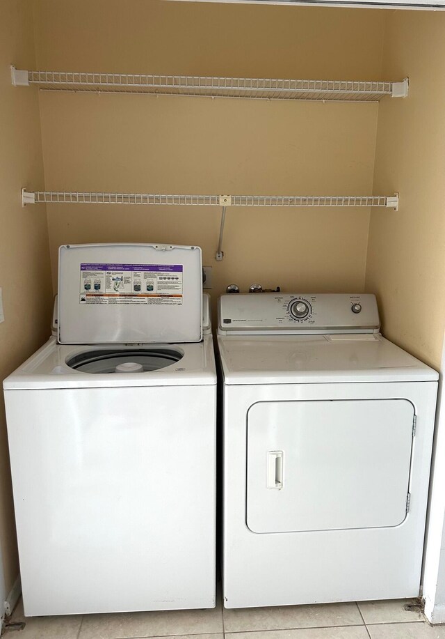 half bathroom with baseboards, toilet, and tile patterned floors