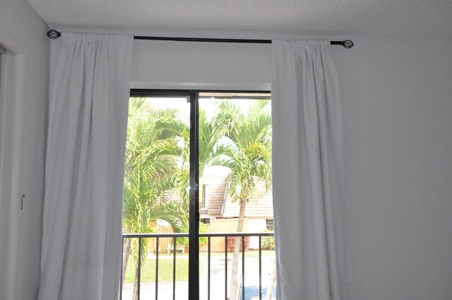 unfurnished room featuring visible vents, light wood-style floors, a ceiling fan, a textured ceiling, and baseboards