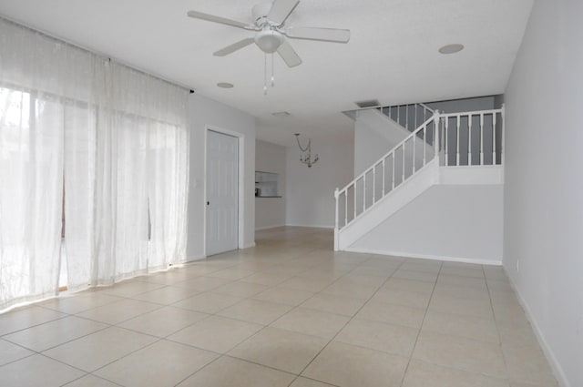 kitchen with white cabinets, white dishwasher, stainless steel range with electric cooktop, black microwave, and a sink