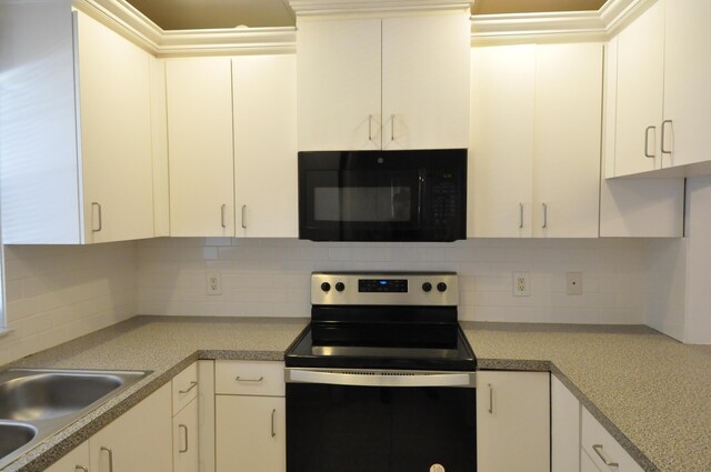 kitchen featuring black microwave, white cabinetry, white fridge with ice dispenser, and stainless steel electric stove