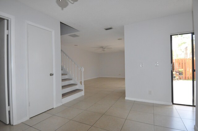 interior space featuring a textured ceiling, tile patterned flooring, visible vents, baseboards, and an inviting chandelier