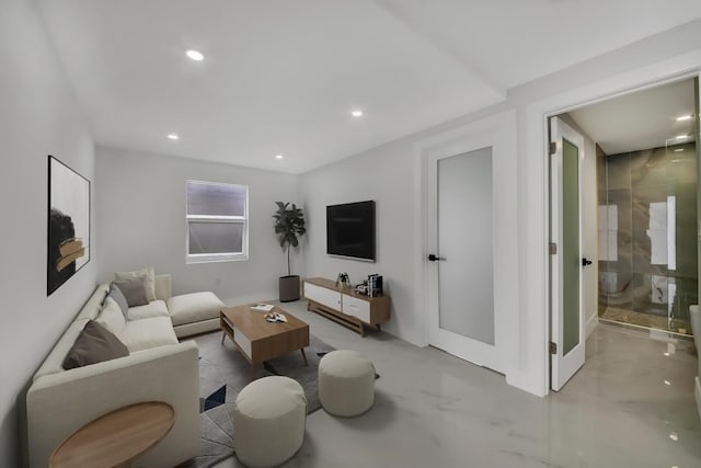 living area with marble finish floor and recessed lighting