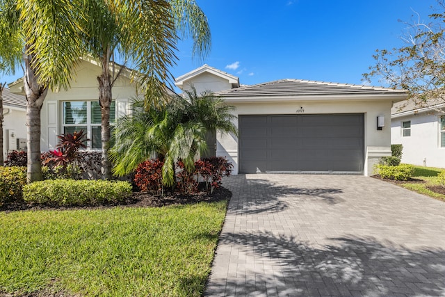 single story home with a front lawn and a garage