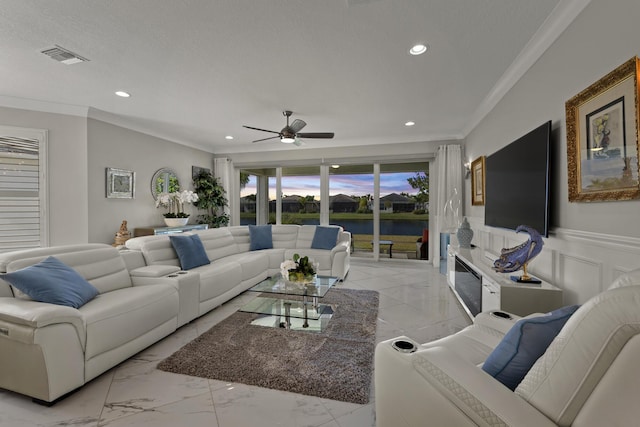 living room with ceiling fan, crown molding, and a textured ceiling