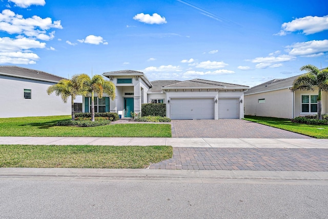 view of front of house with a garage and a front lawn