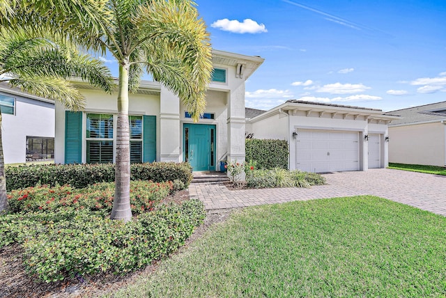 view of front of property with a garage and a front yard