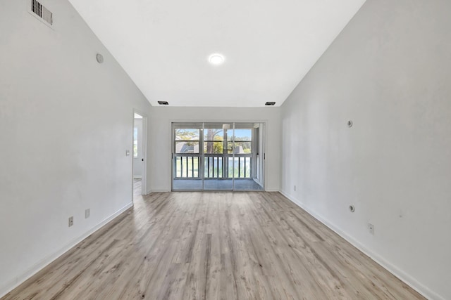 unfurnished living room with light wood-style floors, baseboards, high vaulted ceiling, and visible vents