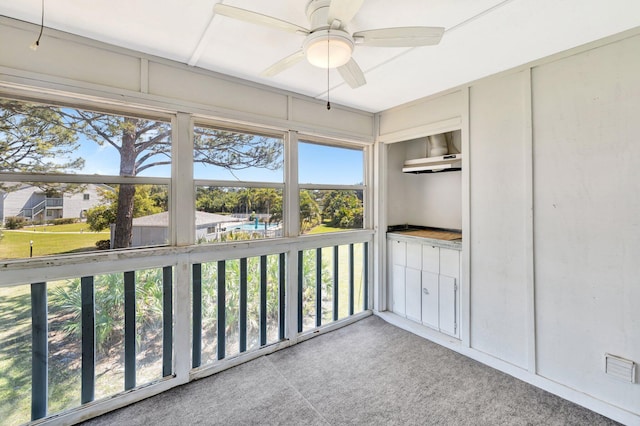 unfurnished sunroom featuring a ceiling fan and visible vents