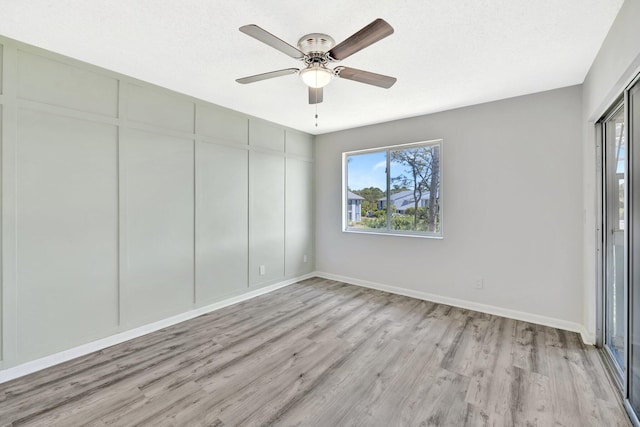 unfurnished bedroom featuring a textured ceiling, baseboards, and light wood-style floors