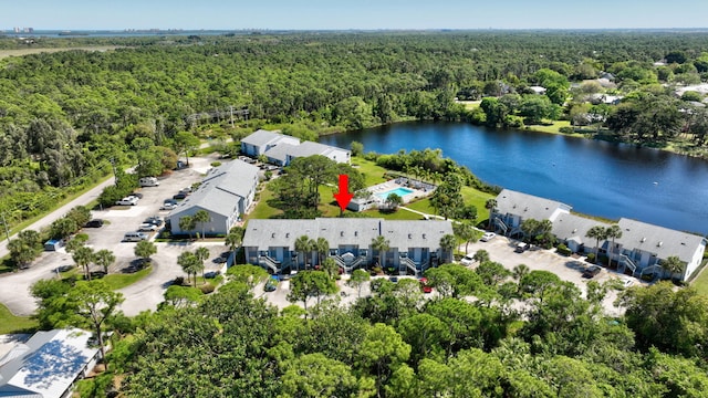 birds eye view of property featuring a wooded view and a water view