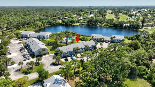 aerial view with a forest view, a water view, and a residential view