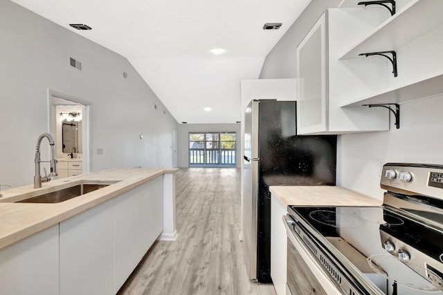 kitchen featuring electric stove, a sink, open shelves, white cabinetry, and vaulted ceiling