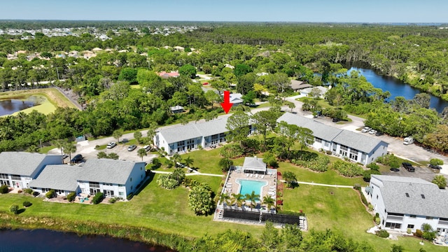 birds eye view of property with a wooded view and a water view