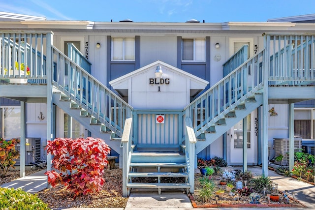 doorway to property featuring covered porch and central AC