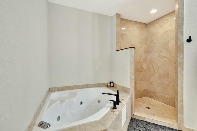 full bathroom featuring a tile shower and a whirlpool tub