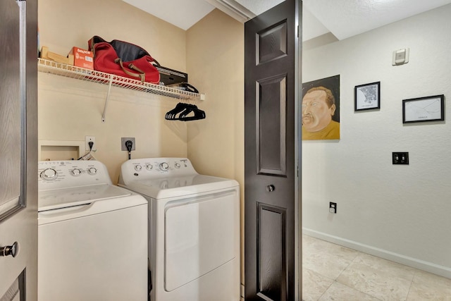 washroom featuring laundry area, light tile patterned floors, baseboards, and washing machine and clothes dryer