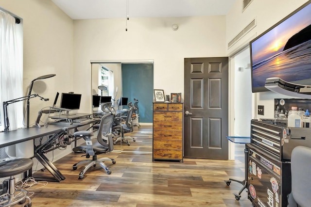 office with visible vents, baseboards, and wood finished floors