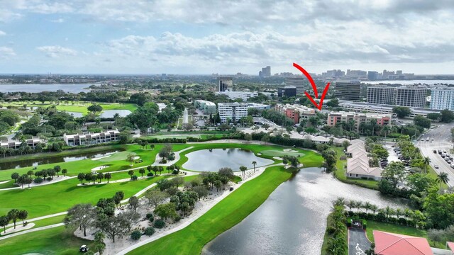 birds eye view of property with a view of city, a water view, and golf course view