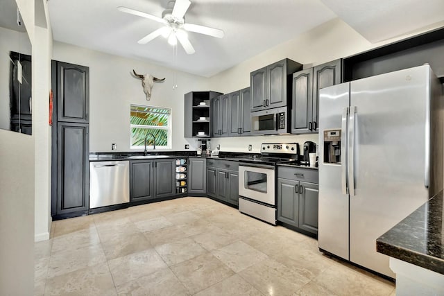 kitchen with ceiling fan, appliances with stainless steel finishes, open shelves, and a sink