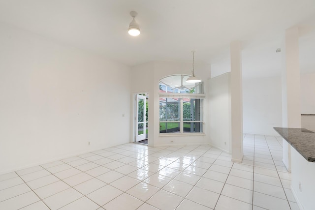 unfurnished dining area featuring light tile patterned floors