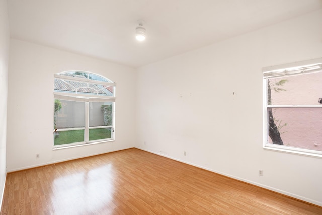 unfurnished room with wood finished floors and baseboards