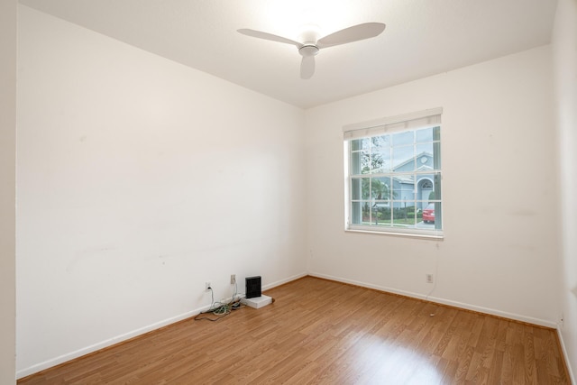 unfurnished room with ceiling fan, baseboards, and wood finished floors