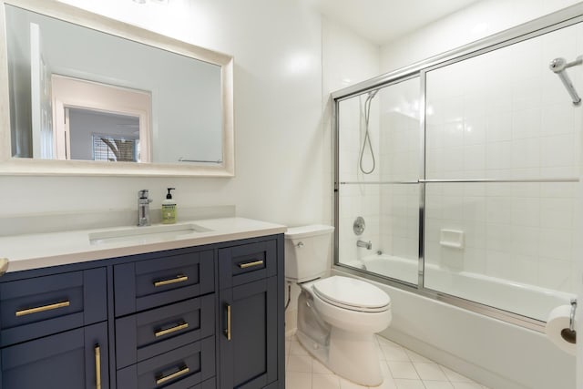 bathroom with toilet, shower / bath combination with glass door, tile patterned flooring, and vanity