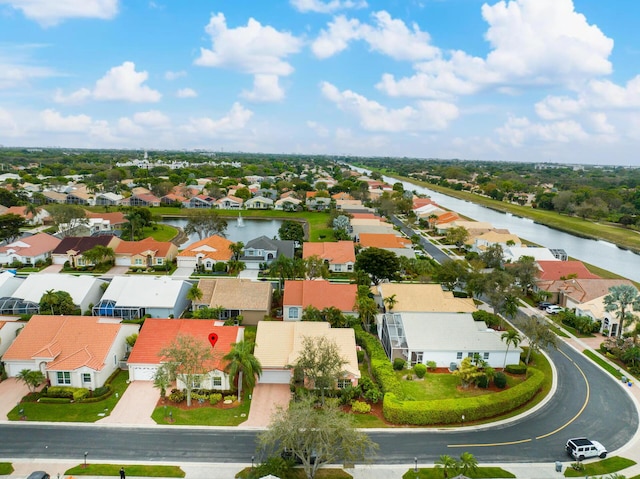 drone / aerial view with a water view and a residential view